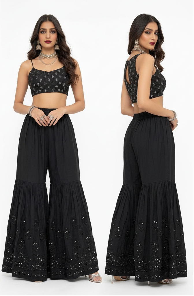 A dual-view studio photograph showcasing the front and back of a model wearing a premium black cotton flared gharara, detailed with intricate handcrafted Kaamdani embroidery along the hem, set against a crisp white background.