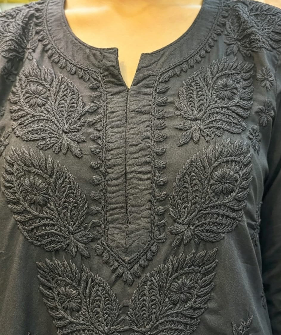 Close-up view of the neckline and detailed embroidery on a black short kurti, showcasing the individual piece without bottom trousers.