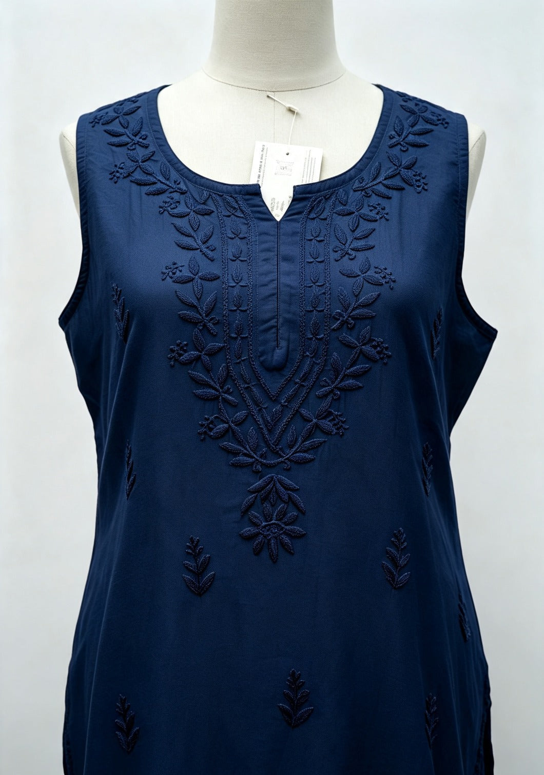 Close-up front view of a deep navy blue handcrafted sleeveless Chanderi silk Chikankari co-ord set displayed on a mannequin, highlighting the intricate tonal embroidery along the neckline and front.