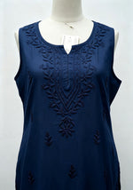 Close-up front view of a deep navy blue handcrafted sleeveless Chanderi silk Chikankari co-ord set displayed on a mannequin, highlighting the intricate tonal embroidery along the neckline and front.