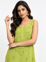 Mode is wearing a sleeveless lime green tunic viscose fabric dress with mulmul lining hand embroidered intricate floral embroidery on the front, shown against a plain white background.