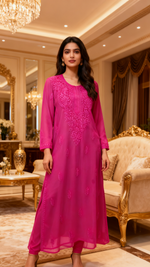 Woman in a magenta colour embroidered long kurti.