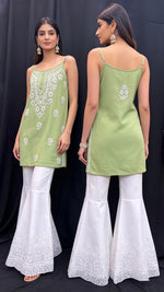 Model is displaying the front and rear view of the short tunic of mint colour with hand embroidery. 