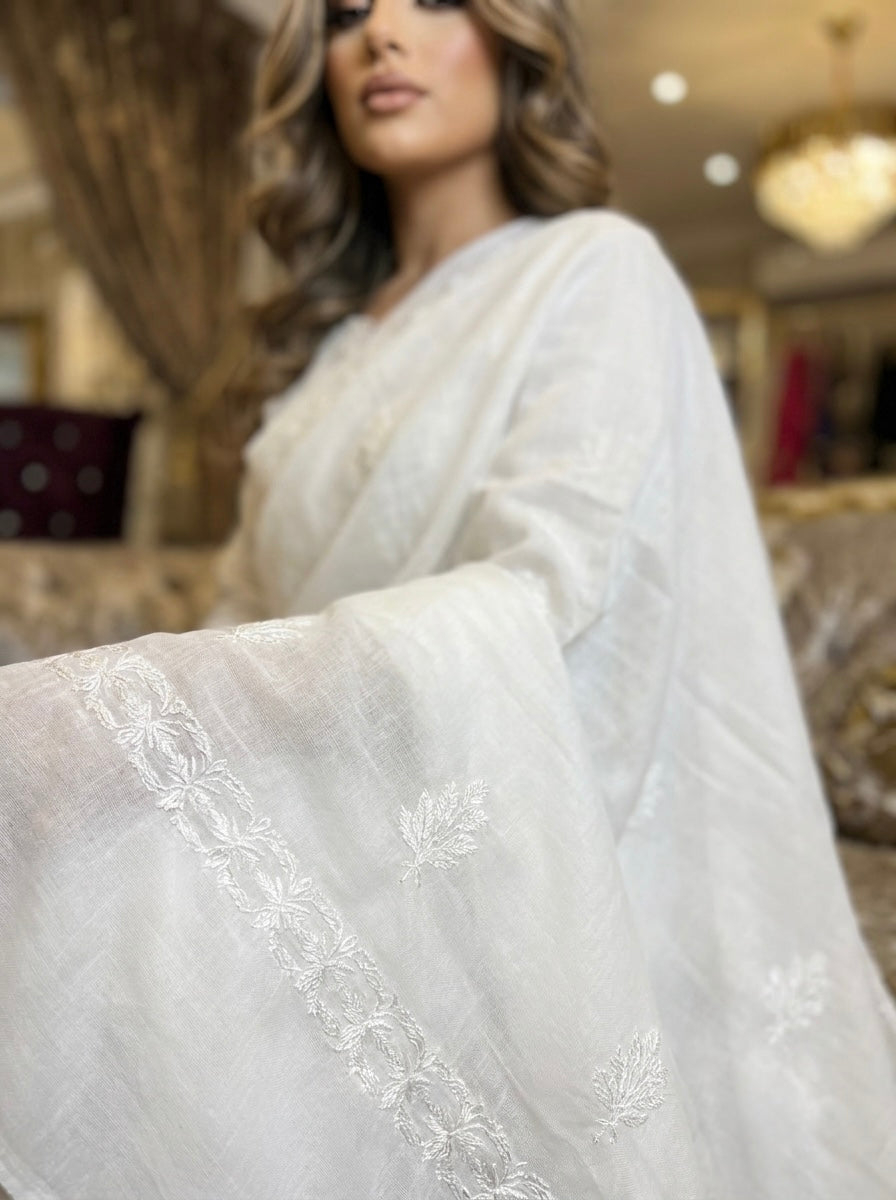 Model is displaying the white shawl with white hand embroidery on it. 