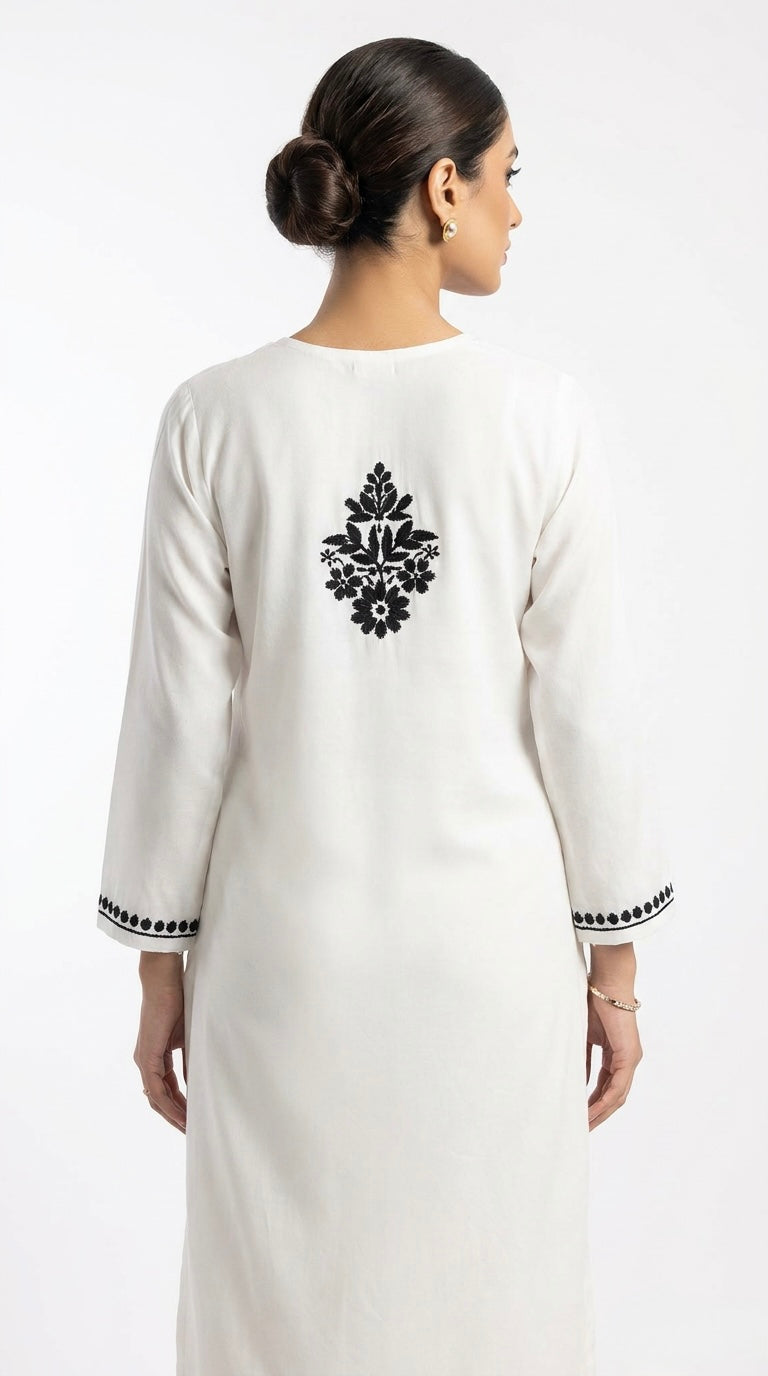 Model is showcasing the white hand embroidered kurti rear view. 