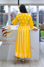 Model is showing the rear view of this Yellow chikankari hand embroidered Aanarkali long dress 