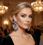 Model is wearing American diamond earrings with white and navy blue cubic zirconia stones. 
