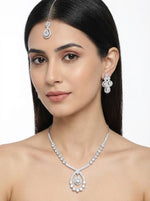 Model is wearing The American diamonds bridal jewellery set including necklace, earrings and maang tikka.