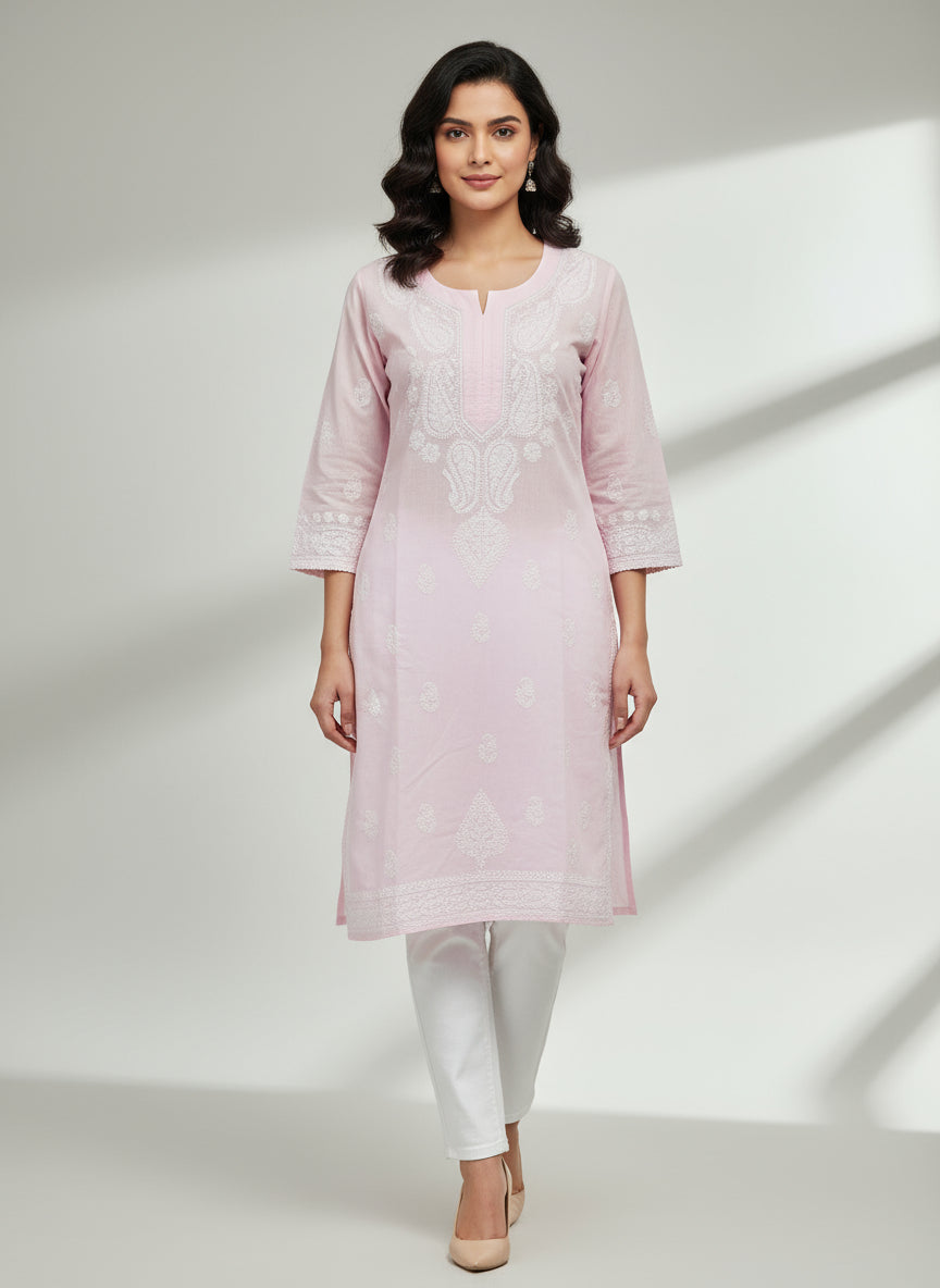 Model is wearing and posing in this powder pink colour cotton kurta front side design with white hand embroidery and wearing white jeans by famaza couture 