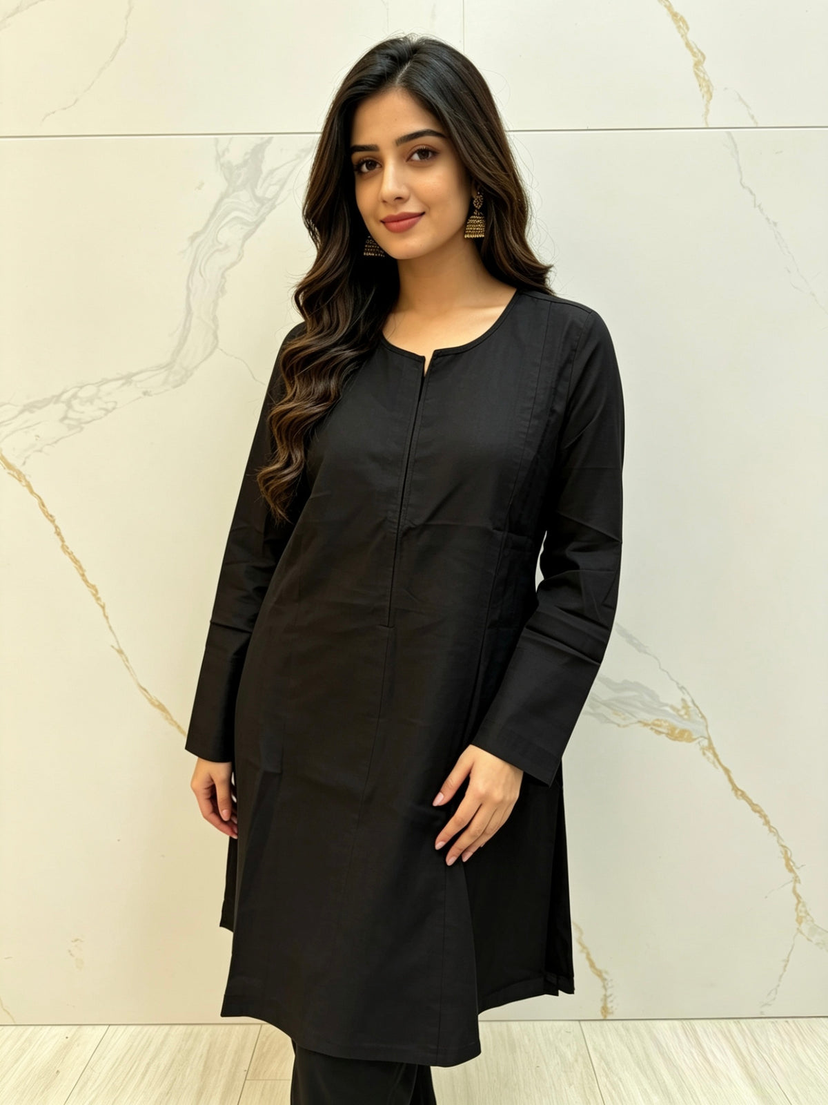 Model is wearing black kurti with its full details showing . 