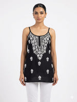 Model is wearing black short noodle tunic. 