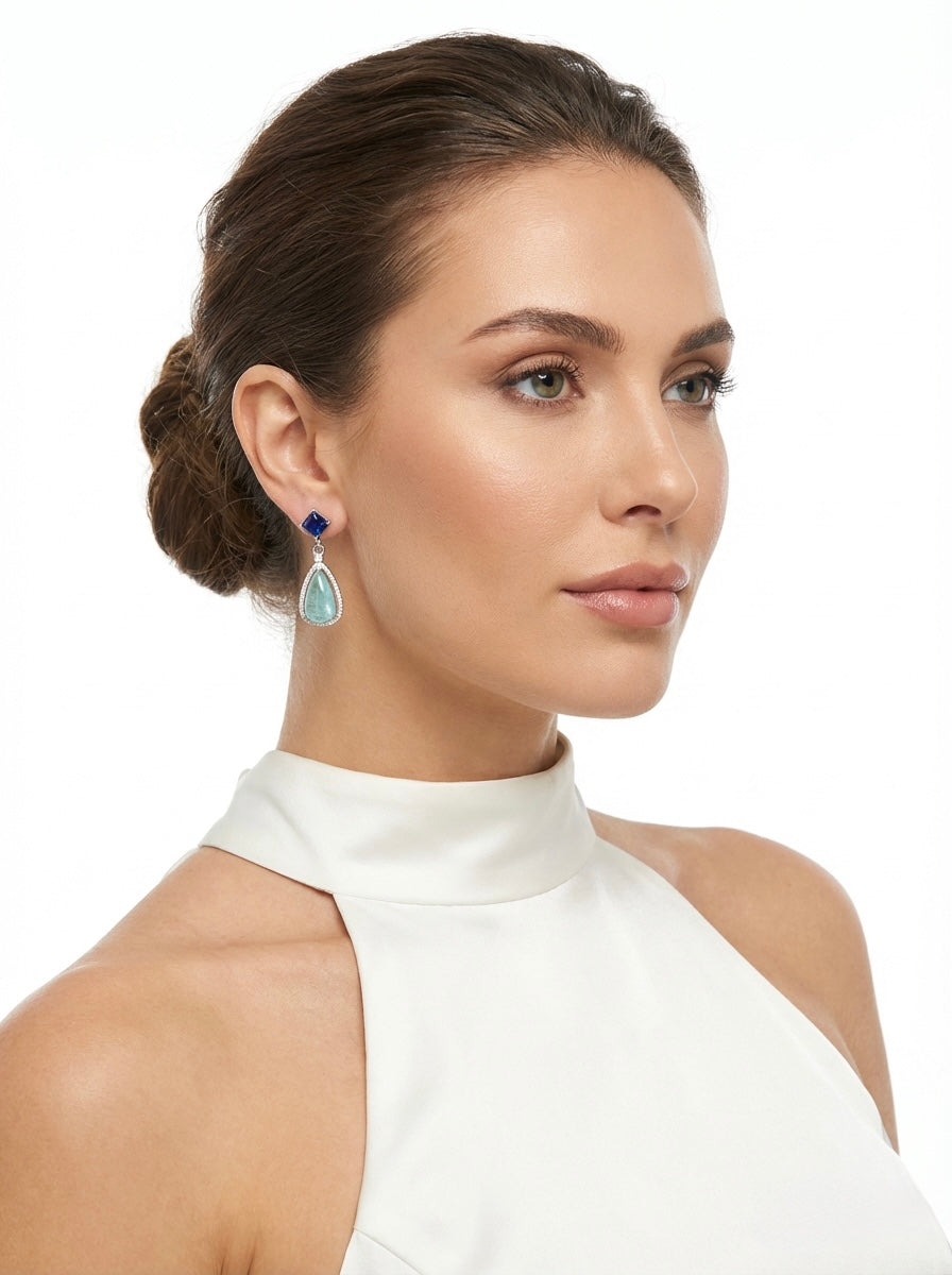 Model is wearing blue and sea green foam colour stones earring. 