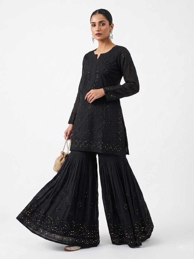 Model is wearing the black cotton Gharara with antique kaamdani work