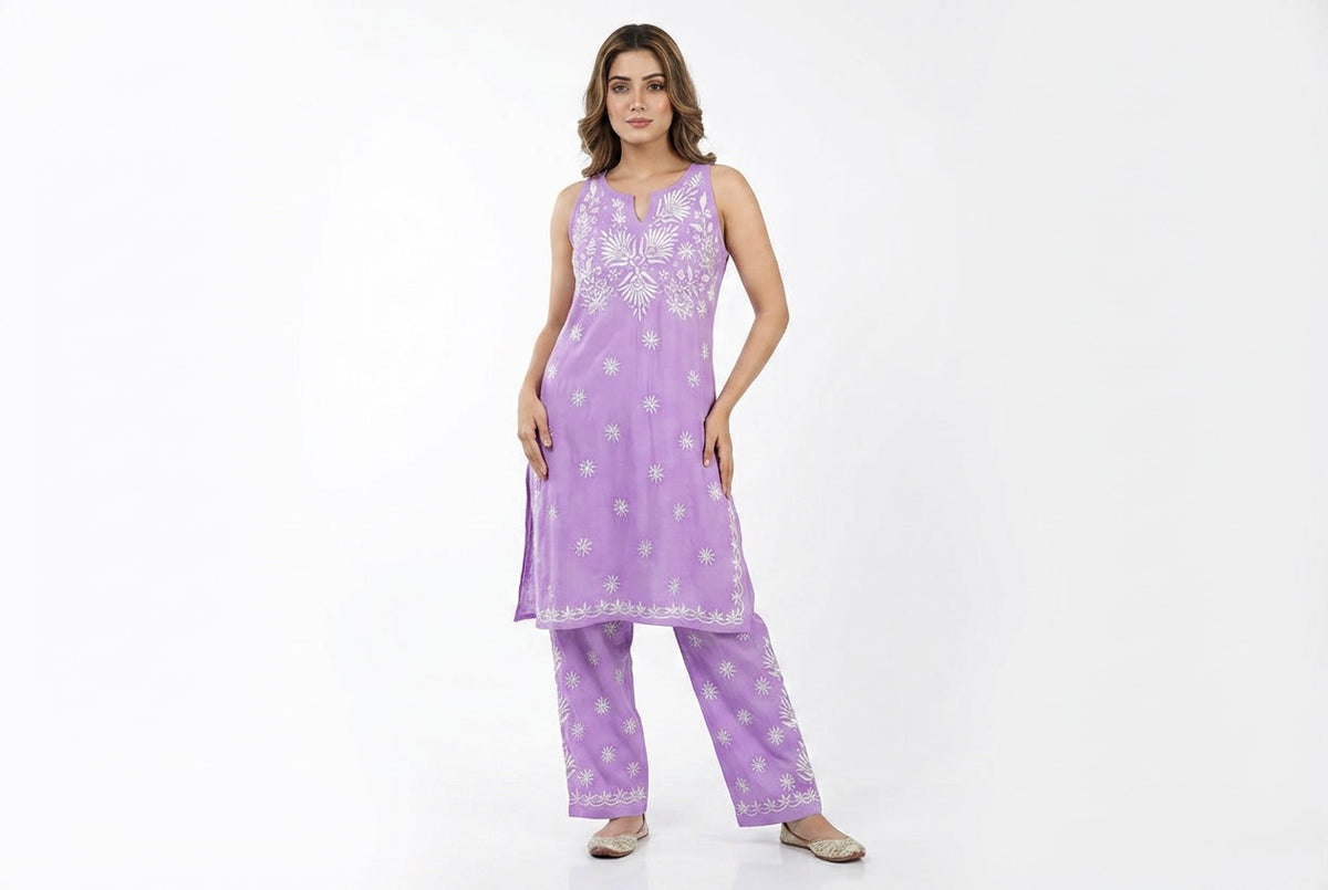Model is wearing this sleeveless kurti and trousers with white hand embroidery . 