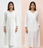 Model is wearing white modal fabric dense Ghasspati embroidery kurti and embroidered trousers. 