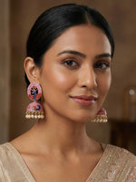 Model showcasing 5.5cm watermelon pink Meenakari jhumkas with a delicate white pearl-fringe finish.