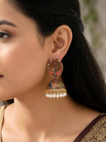 Model wearing earthy brown Meenakari peacock earrings featuring a 3cm wide hand-painted bell drop.