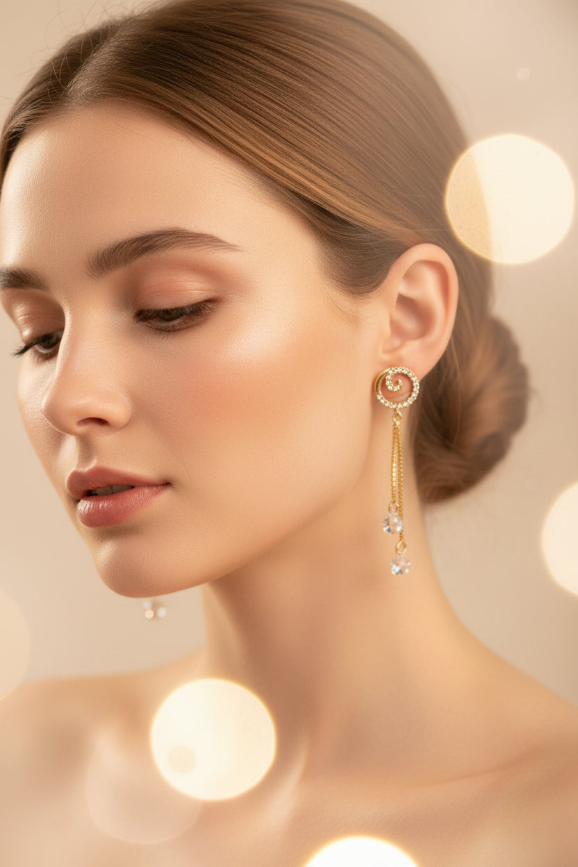 Model wearing the 5cm Vortex rose gold AD earrings, showing how the delicate box chains and spiral studs frame the face with light.