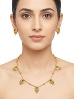 Model wearing the gold-toned brass Minakari necklace set with Emerald Green enamel stones and matching studs.