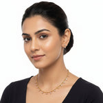 Model wearing the limited edition dainty gold-toned Minakari necklace featuring rare rose gold stones and matching studs.