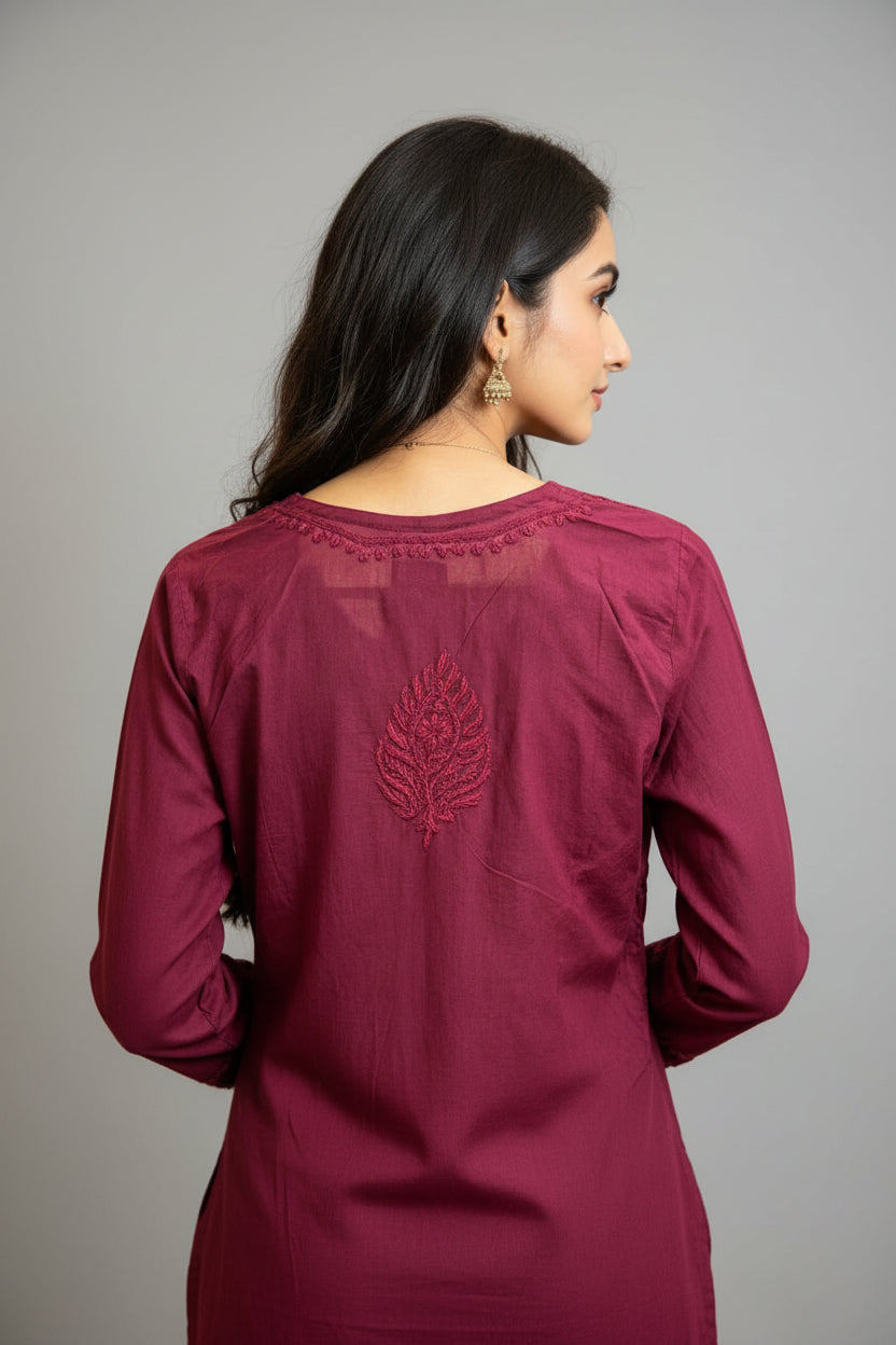 Back view of the plum short kurti showing a detailed embroidered leaf motif on the upper back, presented as a standalone short kurti without bottom trousers.