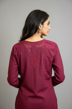 Back view of the plum short kurti showing a detailed embroidered leaf motif on the upper back, presented as a standalone short kurti without bottom trousers.