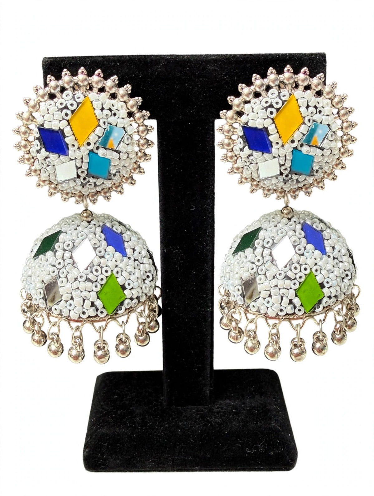 Handcrafted multicolor mirror jhumka earrings: white seed bead base, cobalt blue, bright yellow, turquoise, emerald green & silver mirror inlay, silver bead halo, polished ghungroo drops — traditional Pakistani & Indian festive jewelry.