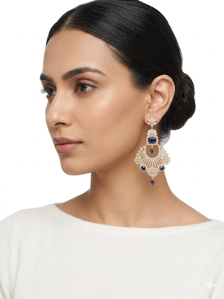 Gold chaand bali chandelier earrings with white American Diamonds and hanging royal blue sapphire gemstones.