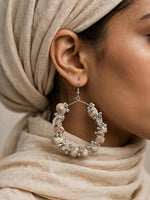 Close-up of Neutral Beige Seashell & Silver Bead Hoop Earring worn on ear, handcrafted design with natural shells and silver-toned beads.