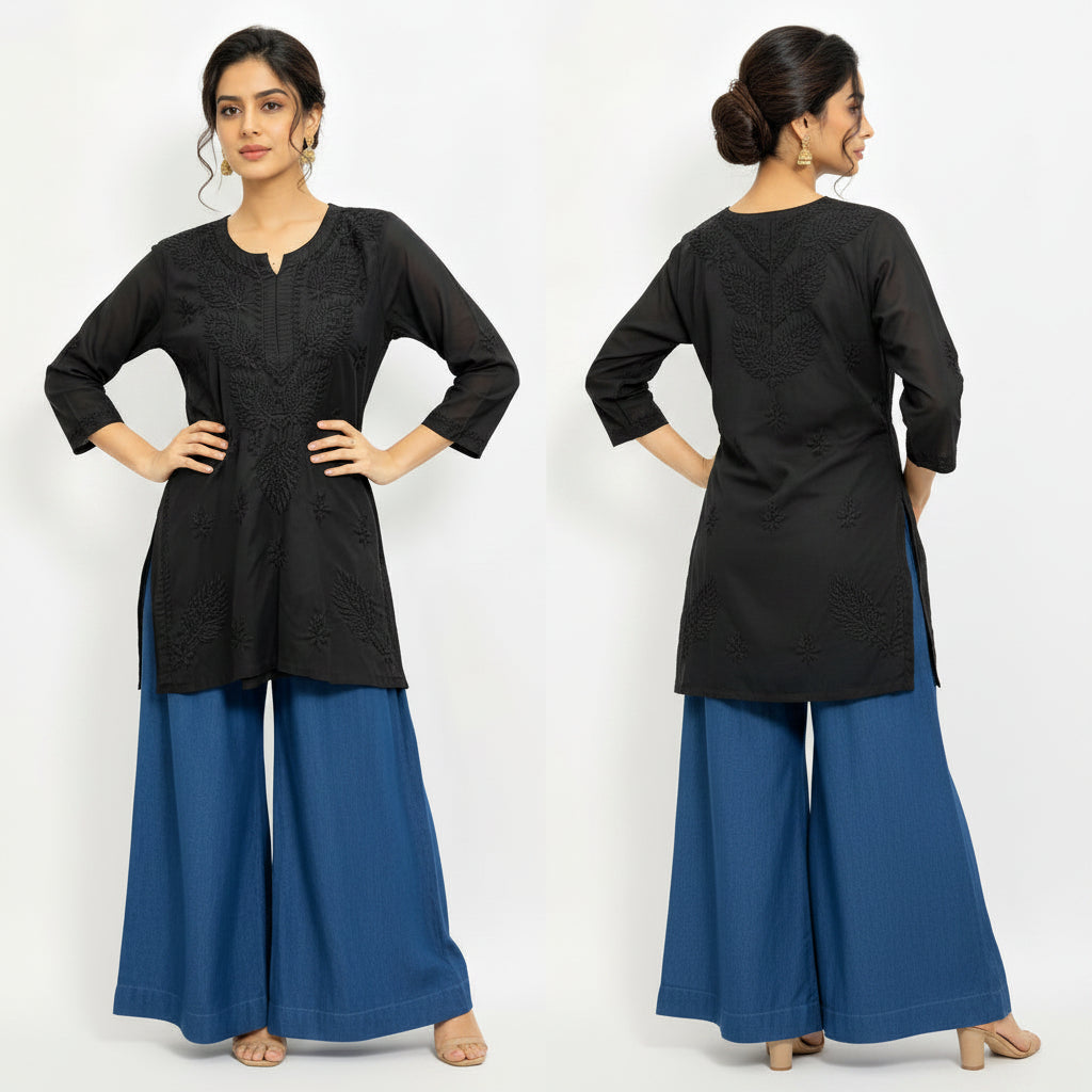 Model wearing a black short kurti featuring intricate leaf embroidery, designed as a standalone short kurti without bottom trousers.