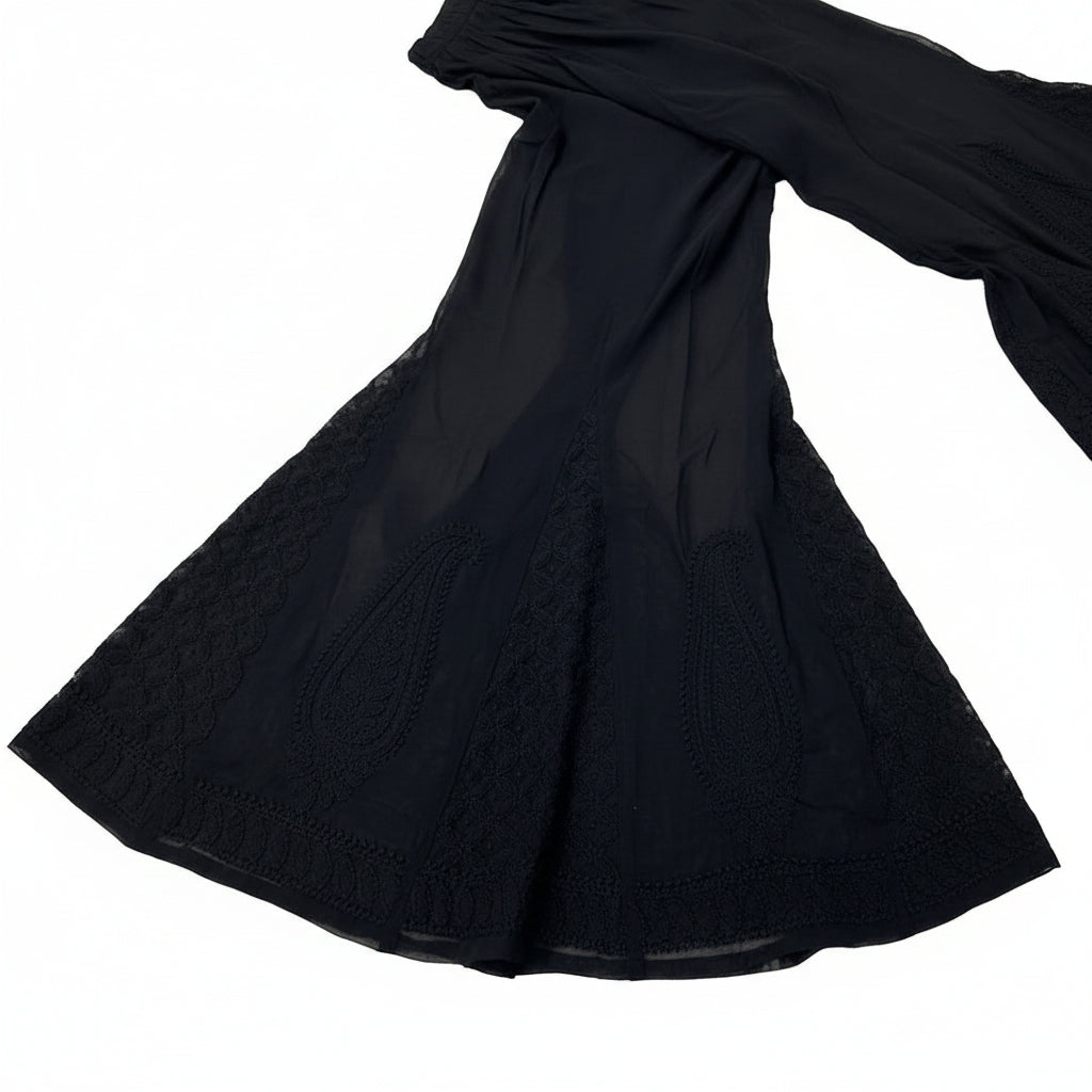 A close-up view of black georgette fabric showcasing detailed tonal paisley and lattice Bakhiya embroidery.