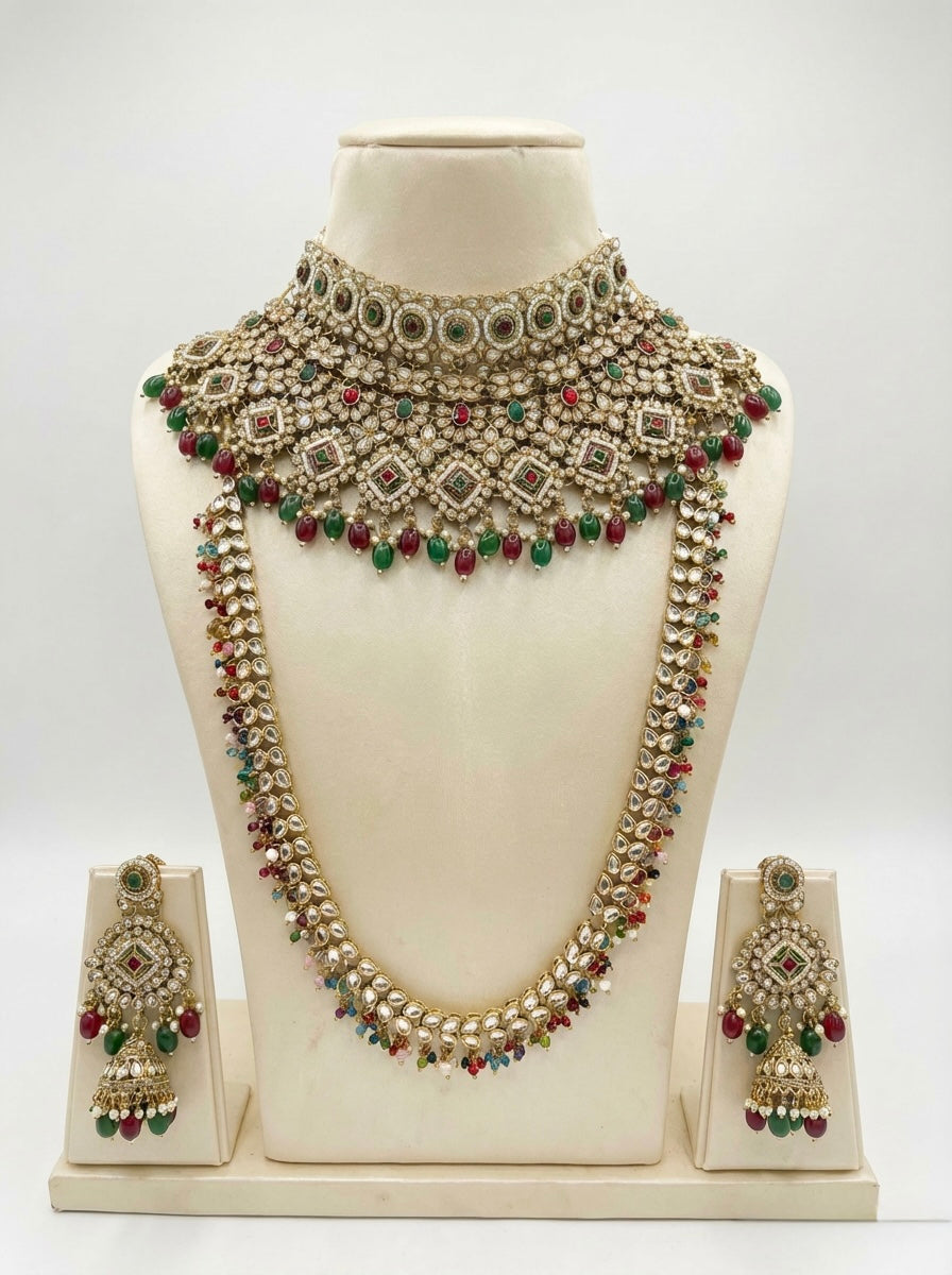 Ornate Bridal Jewellery set including necklace set with green and red stones on a mannequin bust against a white background