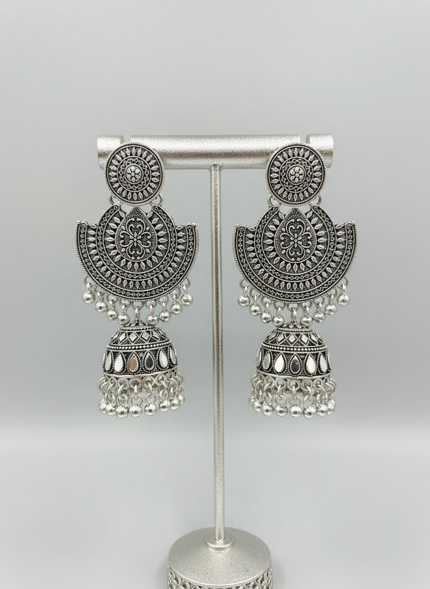 Ornate silver earrings with a small jhumka by famaza couture 