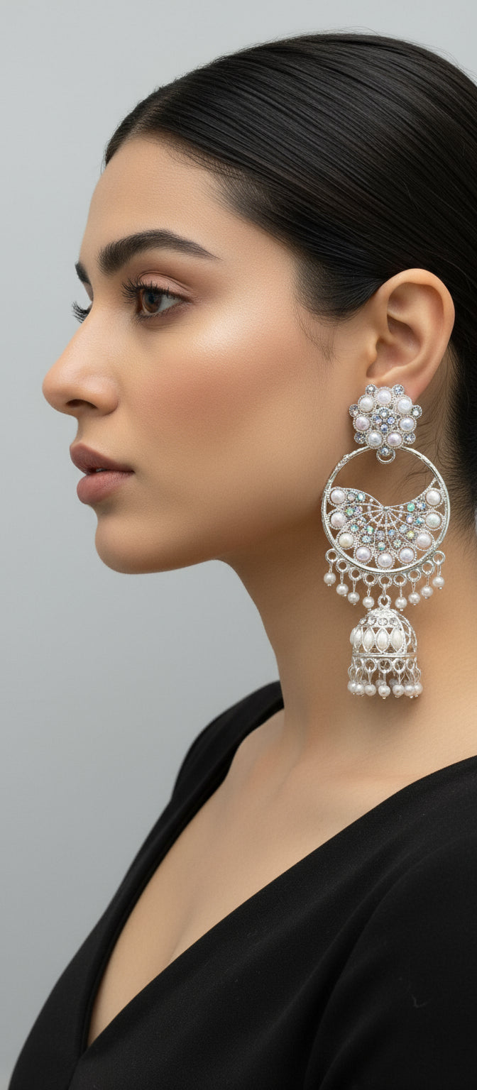 Ornate silver earrings with pearls and gemstones and small jhumka in the bottom by famaza couture 