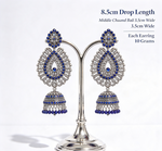 Pair of oxidised silver peacock teardrop jhumka earrings on silver display stand with dimensions — 8.5cm drop, 3.5cm width, 10g each, sapphire navy blue stones, premium bridal jewelry.