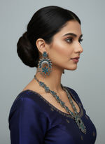 Decorative silver necklace with blue stones on a white fur background