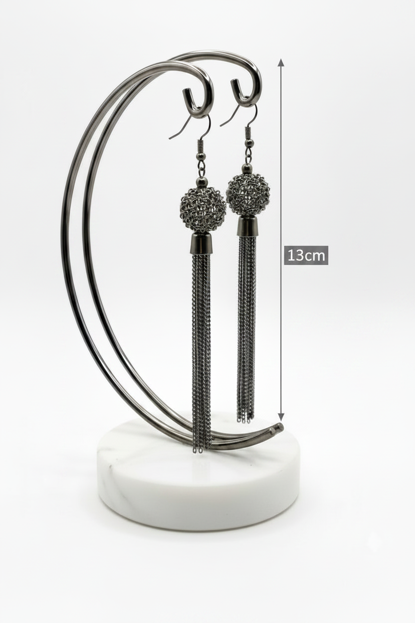 Black tassel earrings on a stand with measurement label