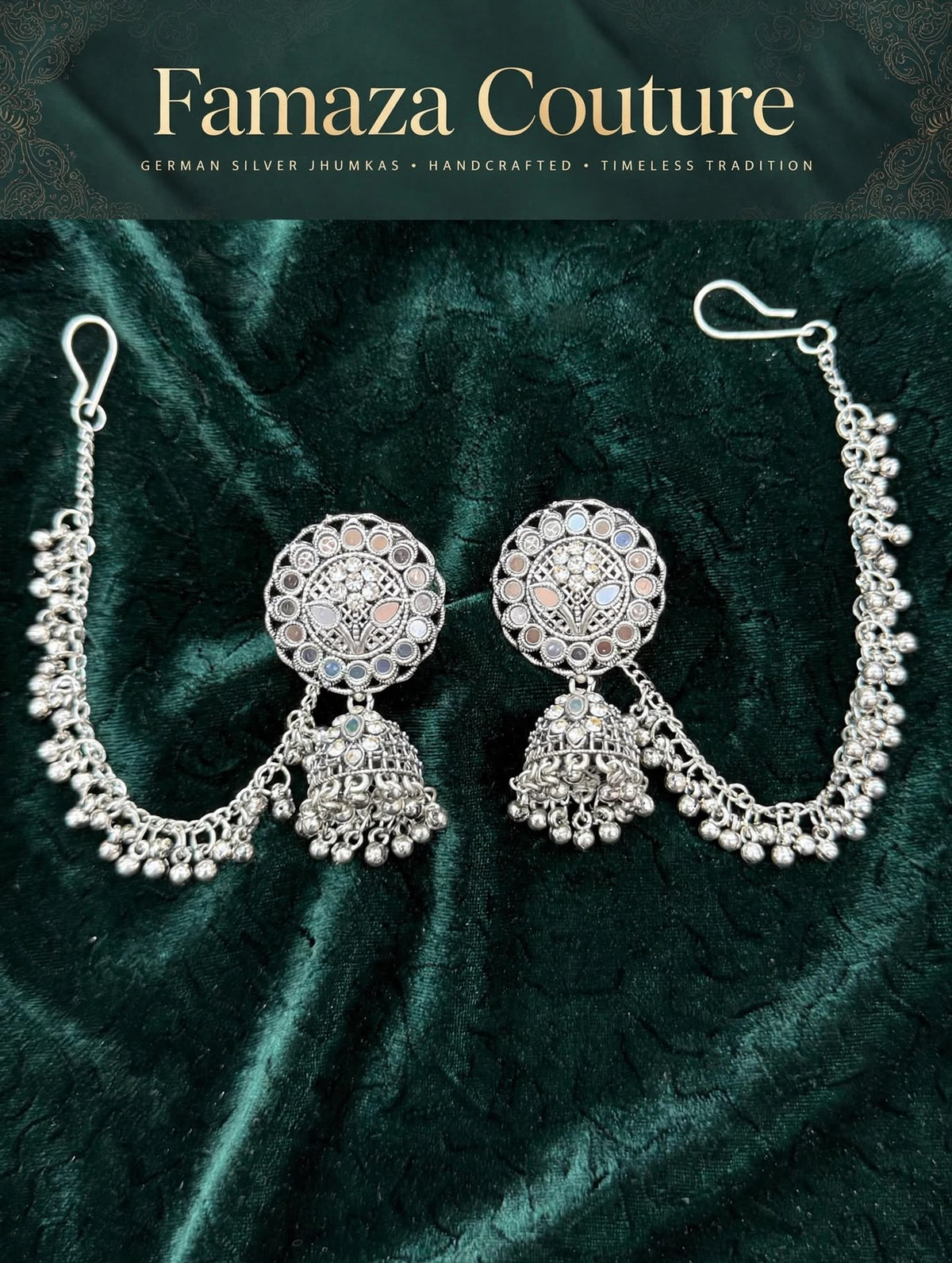 A pair of silver-toned Indian Jhumka earrings with dangling chains, displayed on a dark green velvet fabric background. A dark green banner at the top features the brand name 'Famaza Couture' in gold lettering.