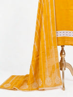 Mustard yellow fabric with white embroidery on a white background