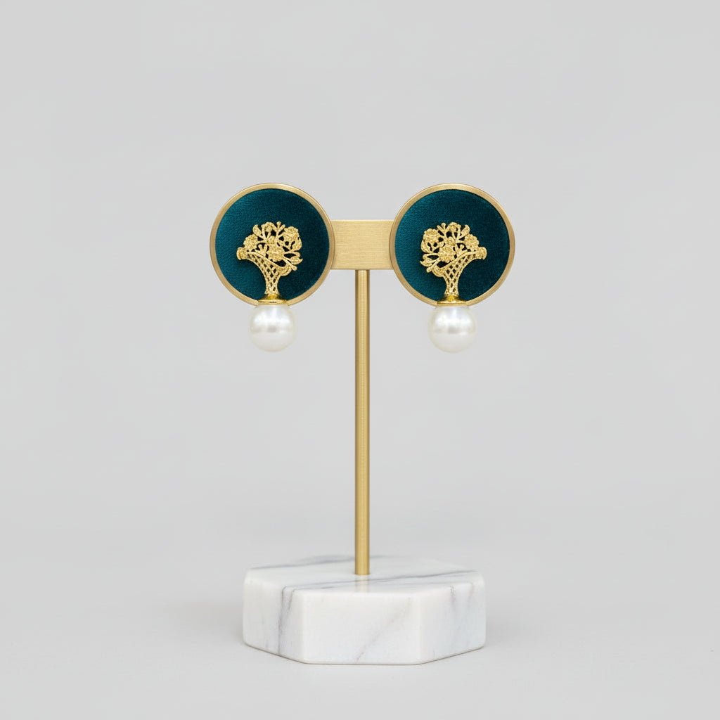 Pair of earrings with gold tops and pearl bottoms.