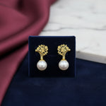 Pair of earrings with gold tops and pearl bottoms 