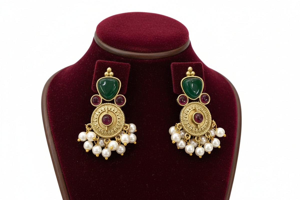 Pair of gold and green earrings with 3 tiny hot pink stones and nano pearls hangings in the bottom.