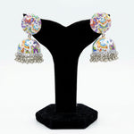 Pair of hand-painted white enamel jhumka earrings decorated with a colorful butterfly motif and dangling metallic beads.