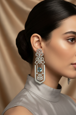 Woman wearing an elegant earring with a beige background