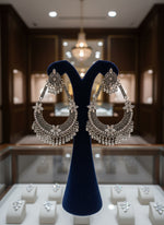 Pair of ornate silver earrings by famaza couture 