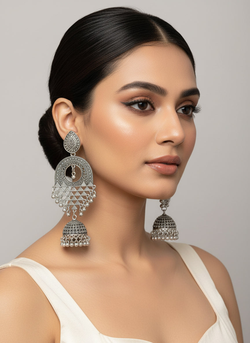 Model wearing silver oxidised filigree drop earrings