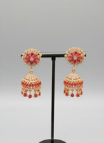 Party wear earrings. A pair of gold-plated jhumka earrings featuring hot pink rhinestones and a floral design. 