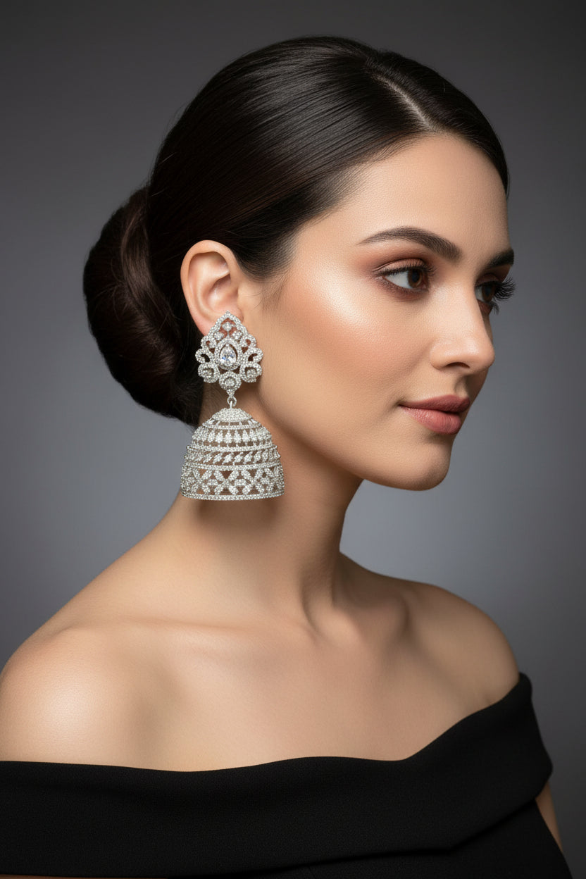 Party wear earrings. Pair of silver American diamonds jhumka earrings. 