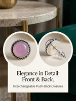A pair of silver-toned push-back stud earrings with oval pink gemstone centers, shown in two circular close-up views with text reading 'Elegance in Detail: Front & Back. Interchangeable Push-Back Closures.