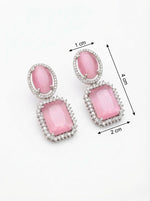 Pink earrings with measurements on a white background